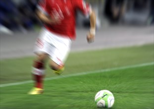 Motion blur of a soccer player in action with a ball