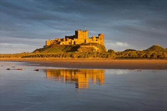 Bamburgh Castle and its reflection in the last light of the day