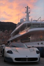 Maserati in front of the motoryacht "Siran" in Port Hercule at twilight