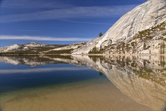 Granite rocks being reflected in Tenaya Lake