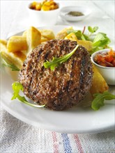 Beef patty grilled with French fries and salad