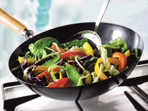Vegetables being stirfried in a wok