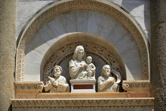 Medieval sculptures of The Madonna and Child above the door to the The Leaning Tower of Pisa