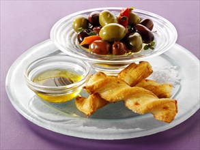 Bowl of mixed olives with bread sticks