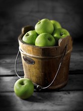 Granny Smith apples in a wooden bucket