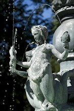 Mermaid holding fish in an Art Nouveau style fountain
