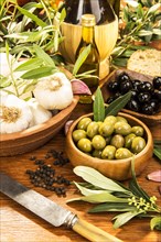 Wooden bowls with green and black olives
