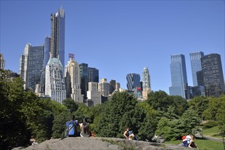 Park visitors with apartment buildings on Central Park South