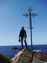 Woman at a summit cross