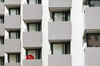Satellite dish with the symbol of the Turkish flag on the balcony of a residential building