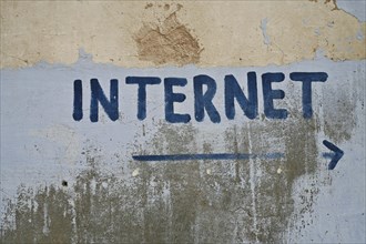 Internet written on a wall with a directional arrow