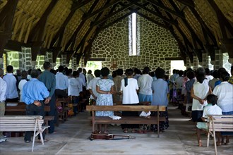 Believers attending a mass in a stone church