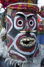 Member of a tribe with a mask at the traditional sing-sing gathering