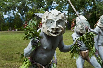 Tribal members in masks and full body paint are celebrating at the traditional Sing Sing gathering in the highlands