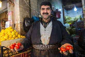 Vendor selling tomatoes in the bazaar of Sulaymaniyah