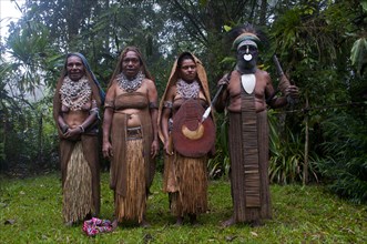 Tribal chief and three women wearing traditional dresses