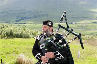Bagpiper in the Scottish Highlands