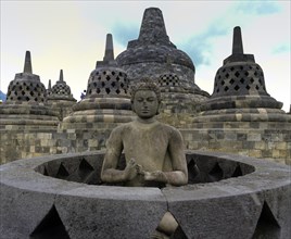 Exposed Buddha statue in the temple complex of Borobudur
