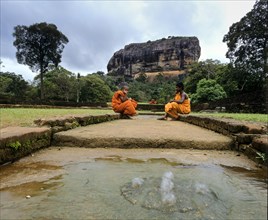 Monks sitting at the cistern