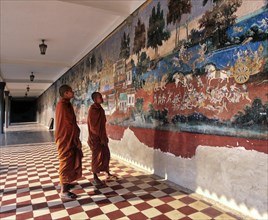 Monks standing in front of a wall painting from the Ramayana epic in the Silver Pagoda or Preah Vihear Preah Keo Morakot