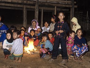 Lahu children sitting around a campfire in a mountain village