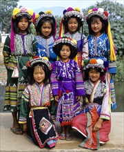 A group of Lisu hill tribe girls wearing traditional costumes and headdresses