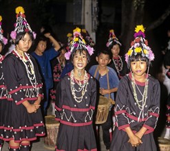 Lahu girls in a mountain village with in traditional costume and headdress