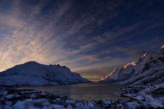 Fjord with small town in the evening light