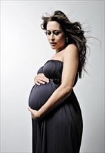 Woman with a pregnant belly wearing a dress