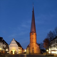 Illuminated Ruhrtalmuseum and St. Victor's Church at dusk