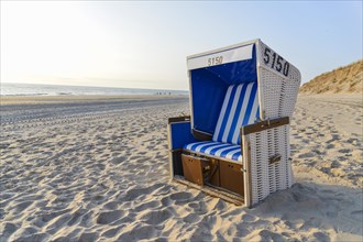 Roofed wicker beach chair on the beach