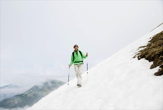 Couple moving over a snow field during their hike to Mt. Neunerkoepfle