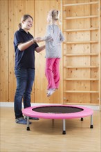 Girl during jump training on a trampoline