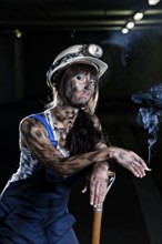 Female mine worker holding a cigarette