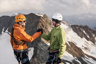 Mountain climbers congratulating one another following the ascent to the summit of Wilder Pfaff Mountain