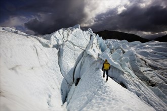Mountaineer standing in front of crevasses on Matanuska Glacier