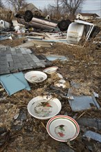 A few dishes survive among the debris from destruction of a seaside community by Hurricane Sandy