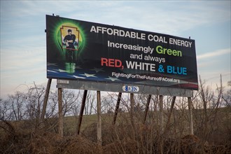 A billboard along a highway promotes "green" coal production
