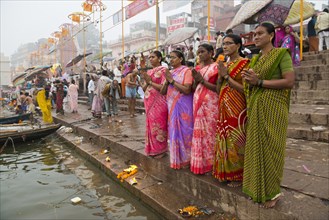 Five women in colorful saris in prayer