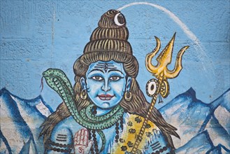 The Hindu god Shiva painted on the wall of a house on the banks of the Ganges River