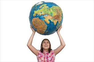 Girl holding up a large globe
