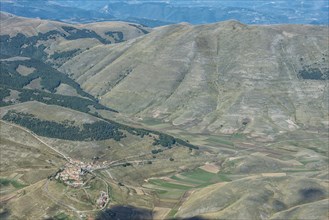 Aerial view of Piano Grande plateau and village of Castelluccio di Norcia