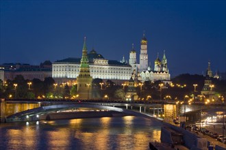 Moscow Kremlin with cathedrals and palace and Bolshoy Kamenny Bridge on Moskva River at night