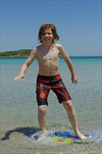 Boy surfing with his boogie board