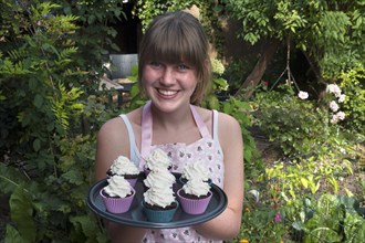 Girl presenting her homemade Oreo brownie cupcakes