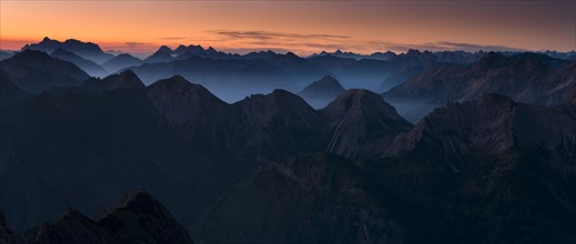 Sunrise above the peaks of the Allgau Alps in steplike arrangement