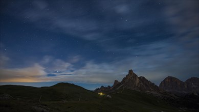 Gusela mountain in a starry night with clouds