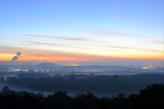 View from the Halde Norddeutschland spoil tip onto the Lower Rhine and the western Ruhr district at dawn