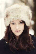 Young woman wearing a fur hat in winter