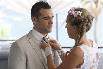 Bride adjusting the groom's tie
